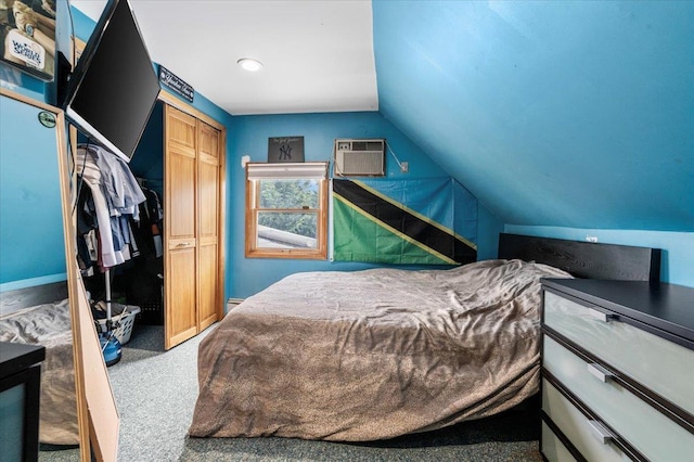 carpeted bedroom featuring lofted ceiling, a wall mounted air conditioner, and a closet