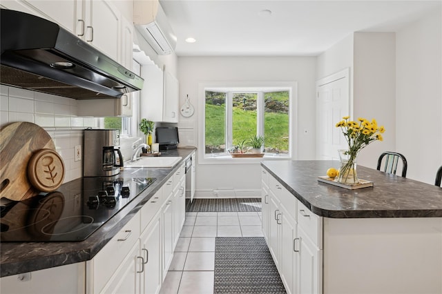 90 Shingle House Rd, Millwood, NY 10546 - kitchen with under cabinet range hood, dark countertops, black electric cooktop, a wall mounted air conditioner, and a sink