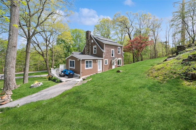 90 Shingle House Rd, Millwood, NY 10546 - view of side of home with a chimney, a deck, a lawn, and a fire pit