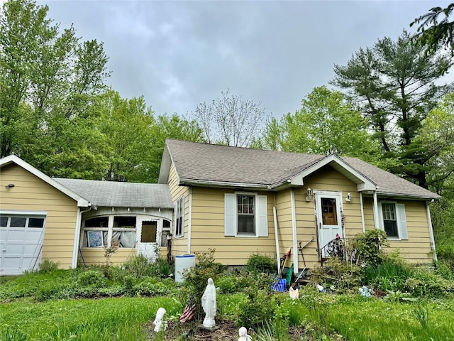 view of front of property with roof with shingles and an attached garage