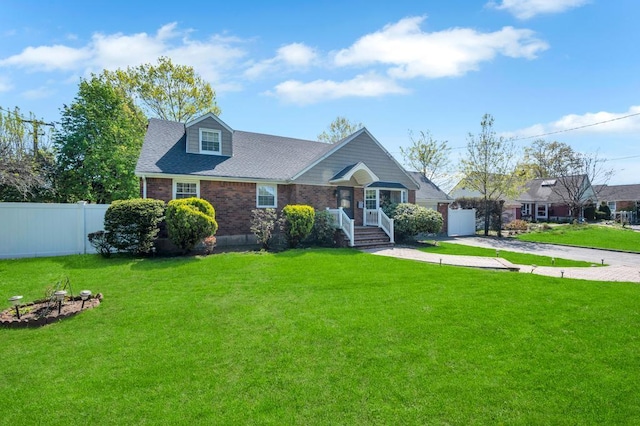 view of front of home with brick siding, a shingled roof, and driveway