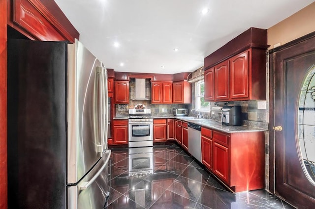 kitchen with stainless steel appliances, wall chimney exhaust hood, dark brown cabinets, and recessed lighting