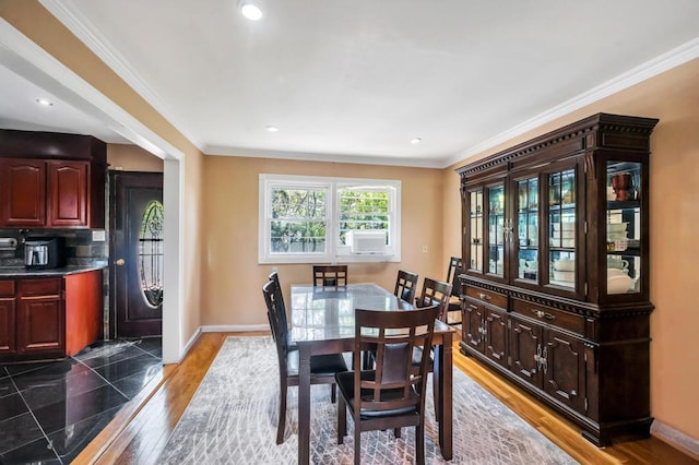 dining area with wood finished floors, ornamental molding, baseboards, and recessed lighting