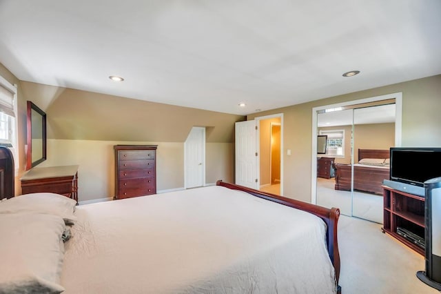 bedroom with carpet flooring, a closet, recessed lighting, and lofted ceiling