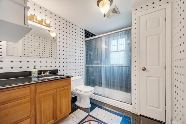 full bathroom with a shower stall, toilet, and vanity