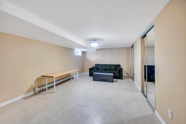 sitting room featuring a baseboard heating unit and baseboards