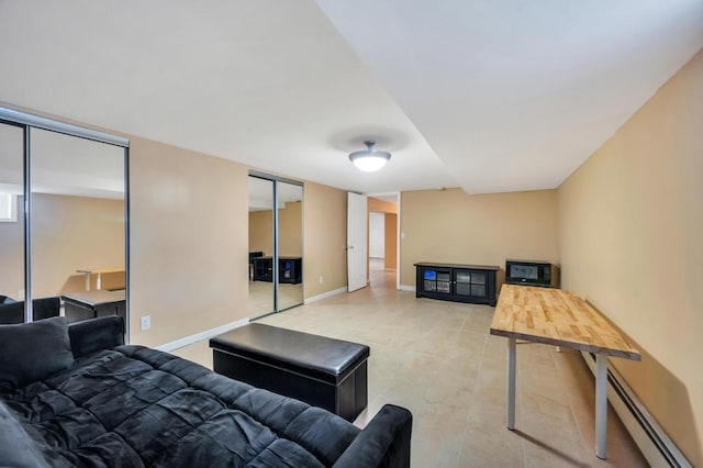 living area featuring a baseboard radiator and baseboards