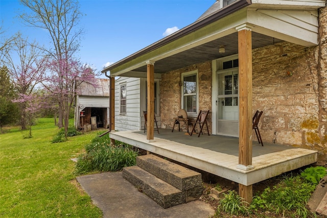 entrance to property with a yard and a porch