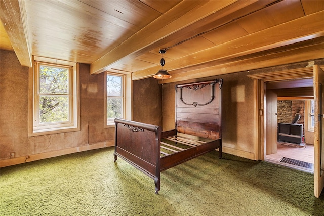 carpeted bedroom featuring wooden ceiling, visible vents, baseboards, and beam ceiling