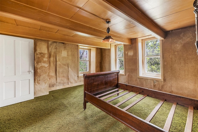 bedroom with carpet, beam ceiling, and wooden ceiling