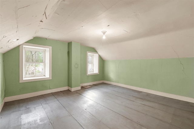 bonus room featuring a wealth of natural light, lofted ceiling, and hardwood / wood-style floors