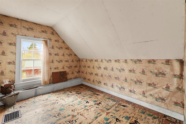 bonus room with lofted ceiling, visible vents, and wallpapered walls