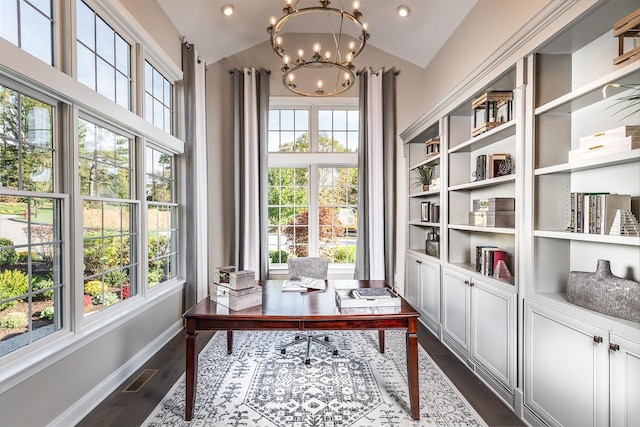 office area featuring healthy amount of natural light, a chandelier, dark wood-style floors, lofted ceiling, and baseboards