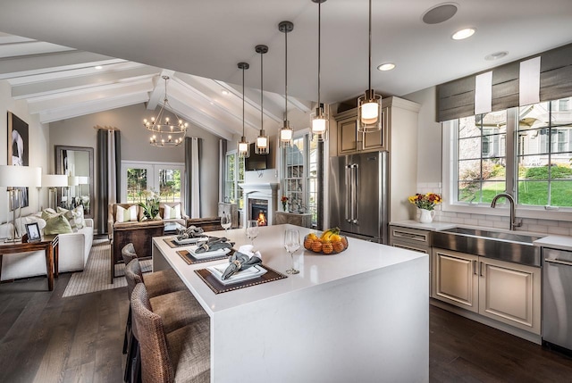 kitchen with stainless steel appliances, open floor plan, light countertops, plenty of natural light, and recessed lighting