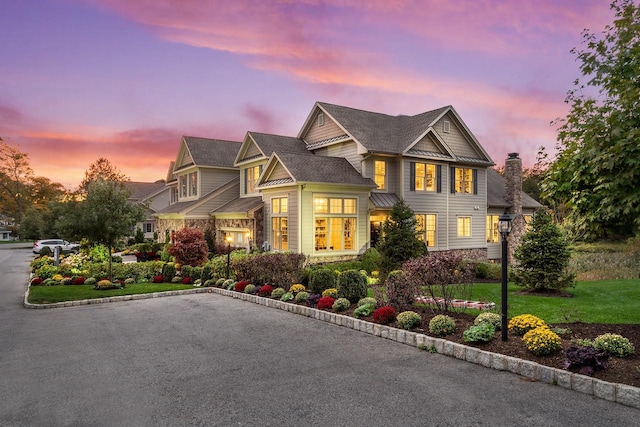 view of front of home with a lawn and stone siding