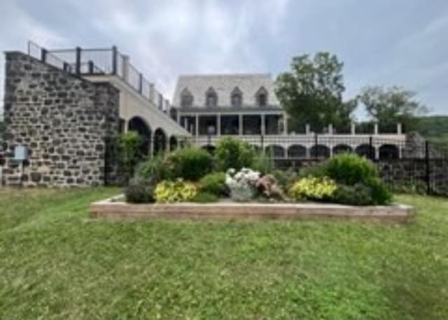 back of property with a lawn