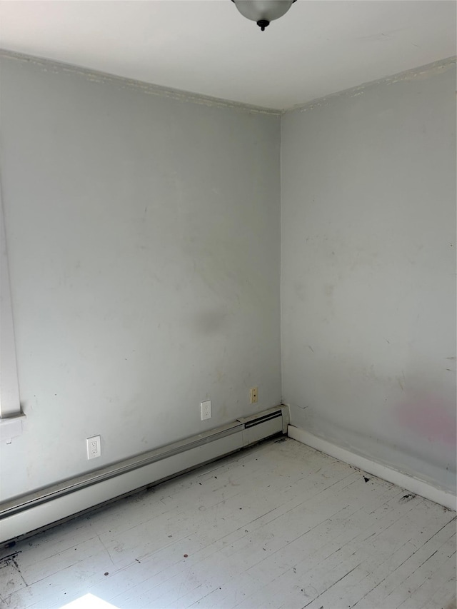 unfurnished room with light wood-style floors, baseboards, and baseboard heating