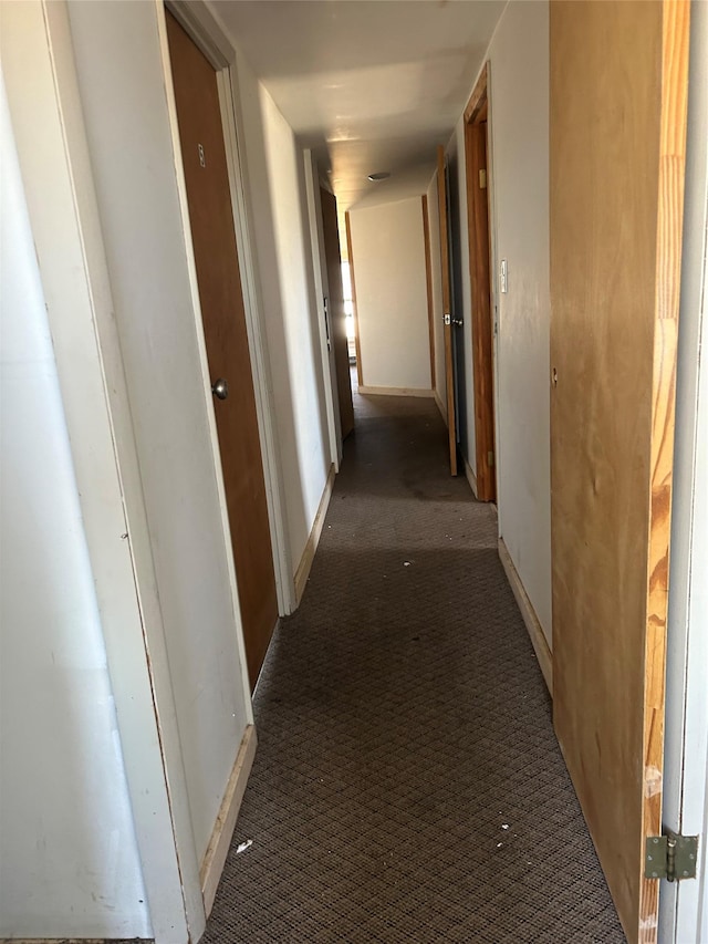 corridor with carpet and baseboards