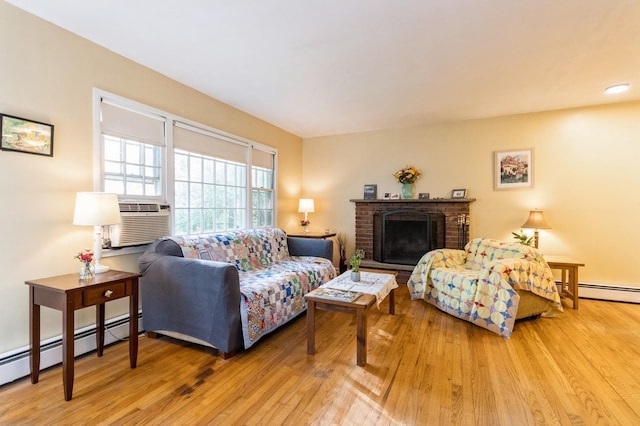 living room with cooling unit, light wood-style flooring, a fireplace, and a baseboard heating unit