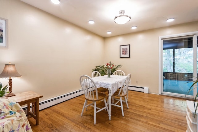 dining room with light wood-style floors, baseboard heating, and recessed lighting