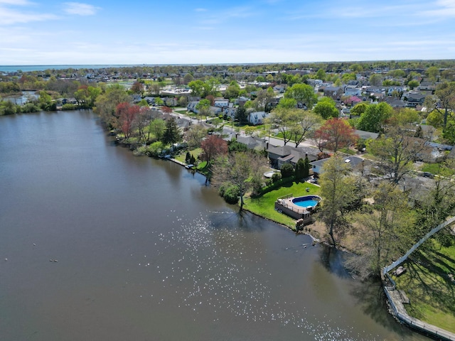 drone / aerial view with a water view and a residential view