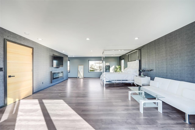 110 Schooner Ln, Copiague, NY 11726 - bedroom with an accent wall, wood finished floors, wallpapered walls, and recessed lighting