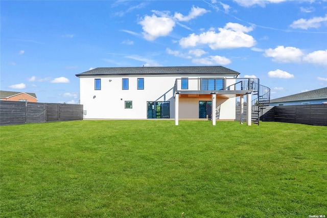 110 Schooner Ln, Copiague, NY 11726 - back of house featuring a yard, stucco siding, stairway, and a fenced backyard