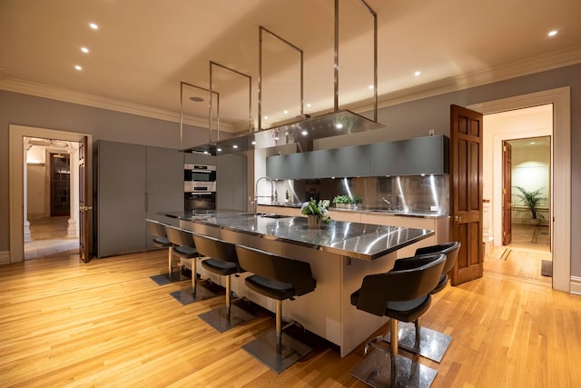 422 Hardscrabble Rd, North Salem, NY 10560 - kitchen featuring stainless steel counters, modern cabinets, a kitchen breakfast bar, and a sink