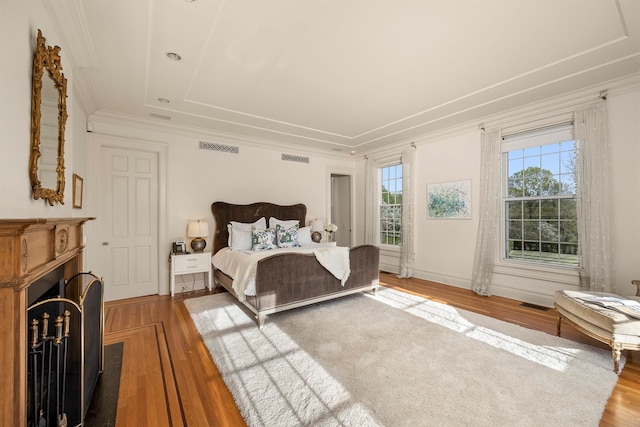 422 Hardscrabble Rd, North Salem, NY 10560 - bedroom with visible vents, a fireplace, crown molding, and wood finished floors
