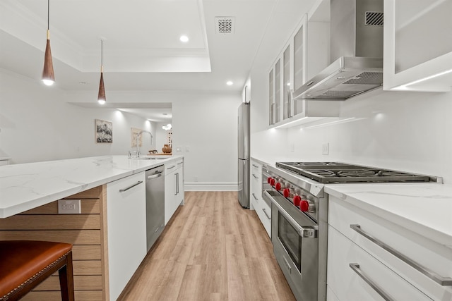 422 Hardscrabble Rd, North Salem, NY 10560 - kitchen with a tray ceiling, a sink, white cabinetry, wall chimney exhaust hood, and appliances with stainless steel finishes