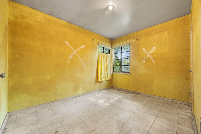 spare room with baseboards