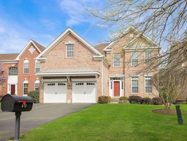 417 Vassar Pl, Fishkill, NY 12524 - traditional home featuring a standing seam roof, driveway, a front yard, a garage, and brick siding