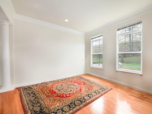 417 Vassar Pl, Fishkill, NY 12524 - empty room featuring baseboards, decorative columns, ornamental molding, and hardwood / wood-style flooring