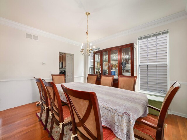 417 Vassar Pl, Fishkill, NY 12524 - dining space with a chandelier, ornamental molding, wood finished floors, and visible vents