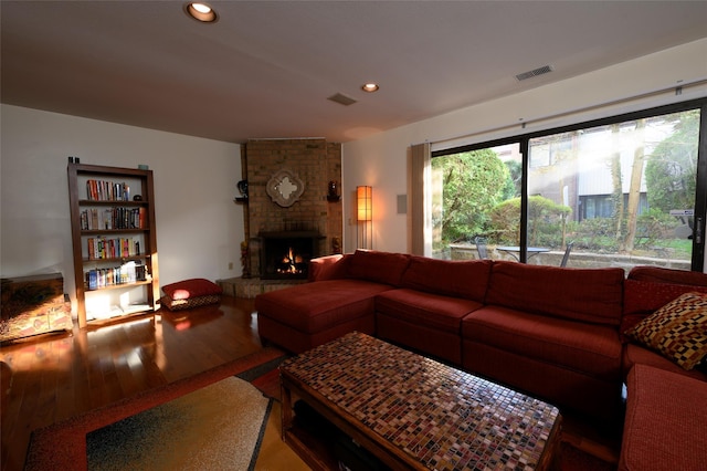 living area with visible vents, wood finished floors, a fireplace, and recessed lighting