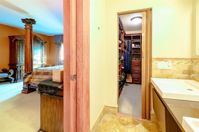 bathroom featuring vanity and a spacious closet