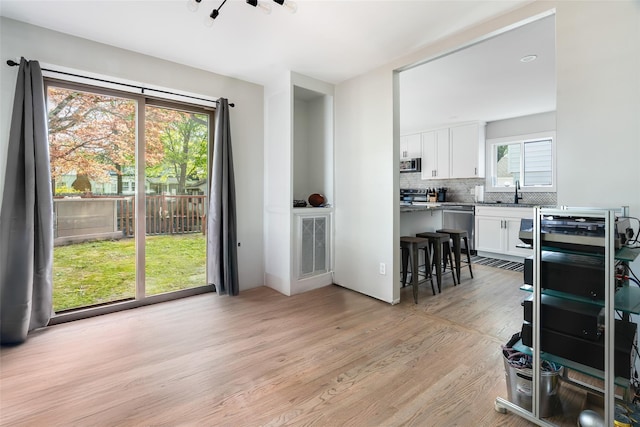 67 Arnett Rd, Rhinebeck, NY 12572 - dining space with light wood finished floors and a chandelier