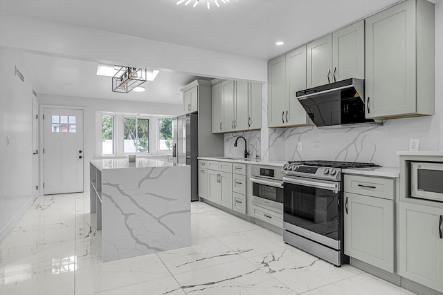 66 Rockland Dr, Jericho, NY 11753 - kitchen featuring stainless steel appliances, exhaust hood, gray cabinets, light marble finish flooring, and a kitchen island