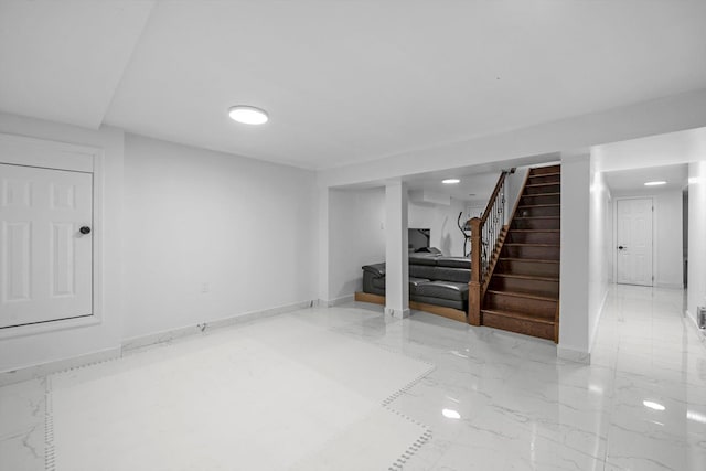 66 Rockland Dr, Jericho, NY 11753 - finished basement with stairs, marble tiled flooring, and baseboards