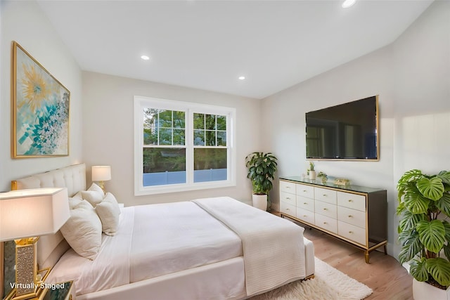 bedroom with light wood-style floors and recessed lighting