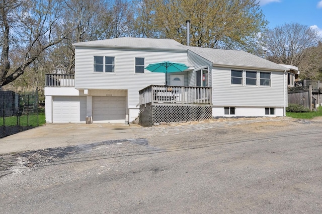 143 Tuthill Rd, Montauk, NY 11954 - split level home featuring concrete driveway and a garage