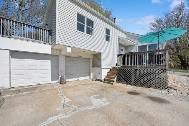 143 Tuthill Rd, Montauk, NY 11954 - rear view of property with an attached garage and concrete driveway