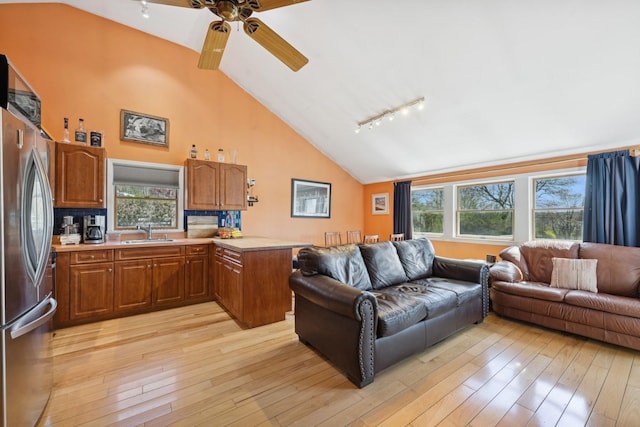 143 Tuthill Rd, Montauk, NY 11954 - living area featuring ceiling fan, light wood-style flooring, high vaulted ceiling, and track lighting