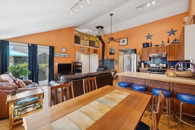 143 Tuthill Rd, Montauk, NY 11954 - dining space featuring light wood-type flooring, high vaulted ceiling, ceiling fan, and track lighting