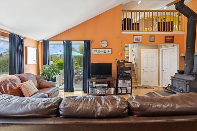 143 Tuthill Rd, Montauk, NY 11954 - living room with a wood stove, stairs, high vaulted ceiling, and plenty of natural light