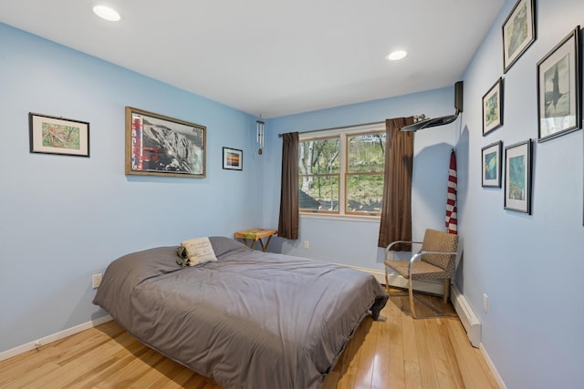 143 Tuthill Rd, Montauk, NY 11954 - bedroom with baseboards, a baseboard heating unit, light wood-style floors, and recessed lighting