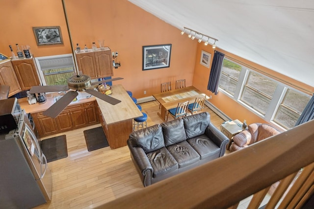 143 Tuthill Rd, Montauk, NY 11954 - interior space with rail lighting, baseboards, baseboard heating, and light wood-style flooring