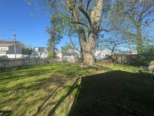 view of yard featuring fence and a residential view