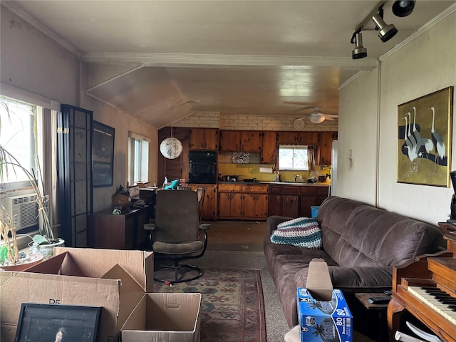 living area featuring dark colored carpet, track lighting, vaulted ceiling, ceiling fan, and cooling unit