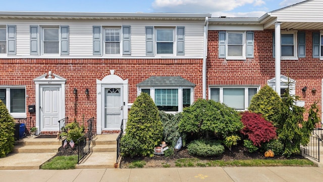 townhome / multi-family property featuring brick siding